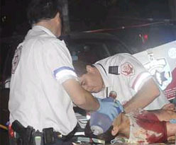 attack248 Rescue personnel treating a victim of the shooting at a gay club in Tel Aviv on Saturday night. (Image from Haaretz.)